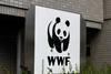 A WWF sign is visible above the foliage outside a building.