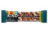 KIND's Dark Chocolate, Nuts and Sea Salt bar is wrapped in flexible plastic. It features a transparent window to see the bar inside, with a black strip featuring the KIND logo on one end of the bar and a green strip reading 'KIND uses recycled plastic'.