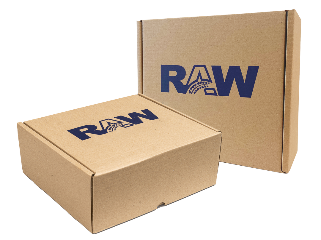 Two brown boxes against a white background. One is laying flat, one standing upright. Both have the 'RAW' logo printed on…