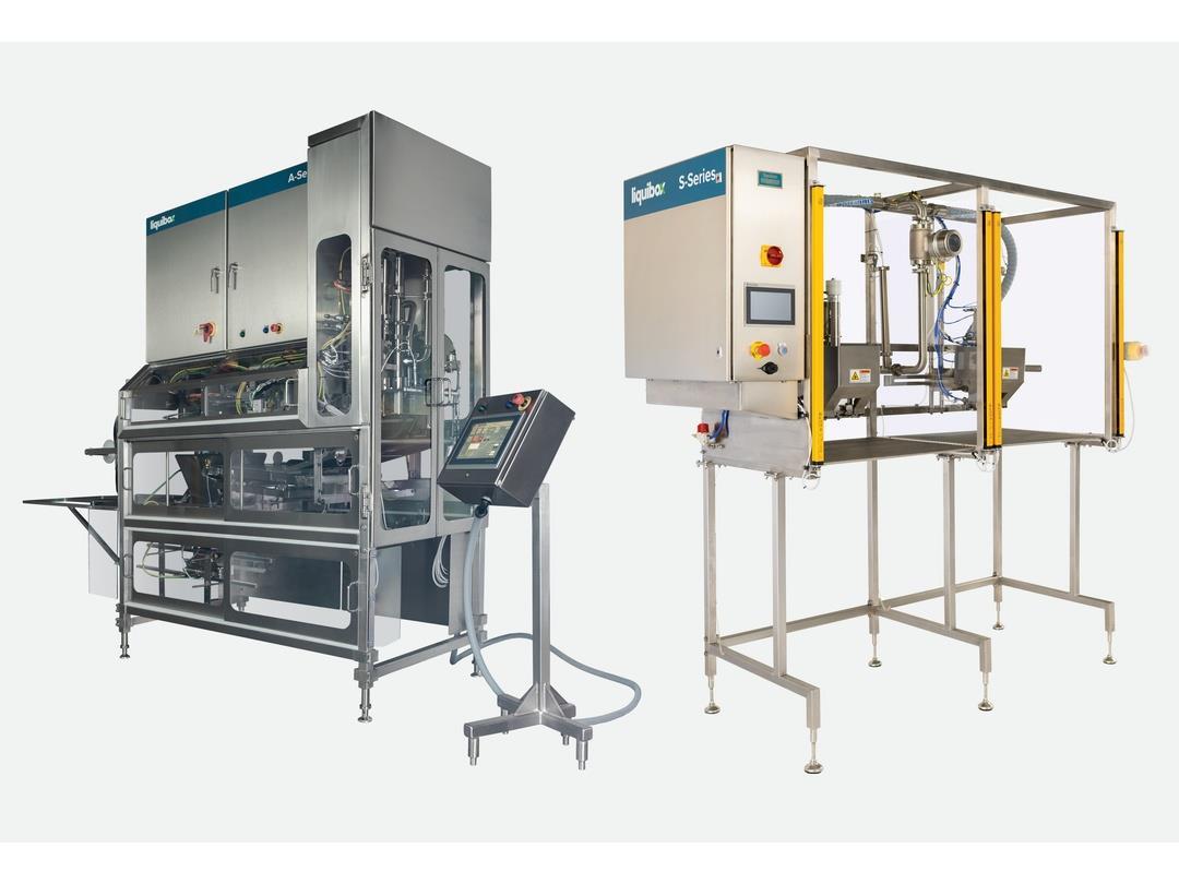 Two Liquibox-branded machines. One has a silver casing, the other white, but both are made of metal, with transparent…