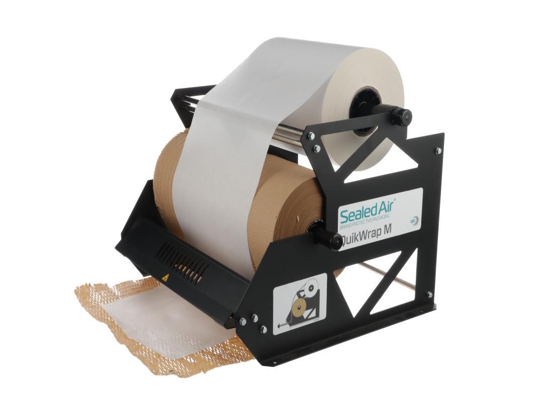 A photograph of Sealed Air's QuikWrap M paper dispenser. It is a metal structure holding two rolls of honeycomb and tissue…