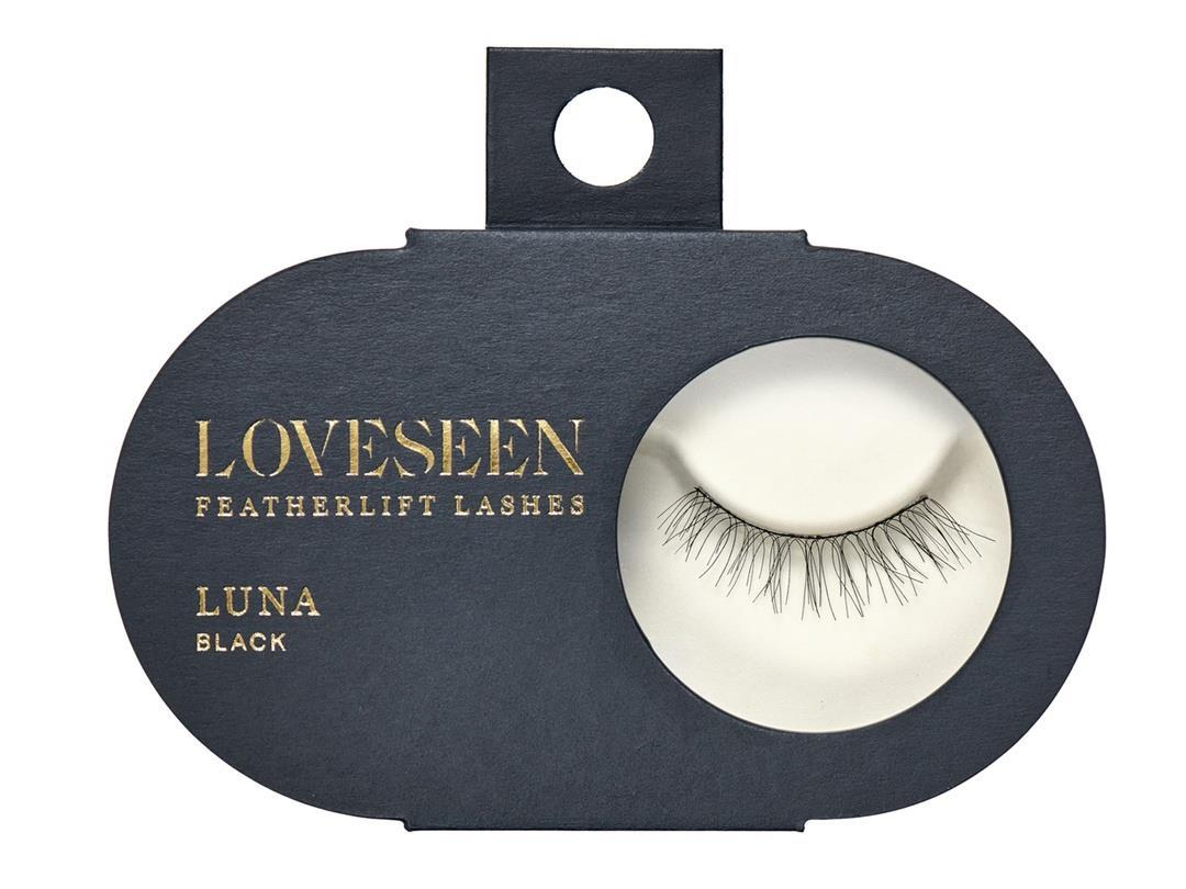 A matte, black, ovular box made of paperboard. It reads 'Loveseen Featherlift Lashes, Luna Black', and contains a round…