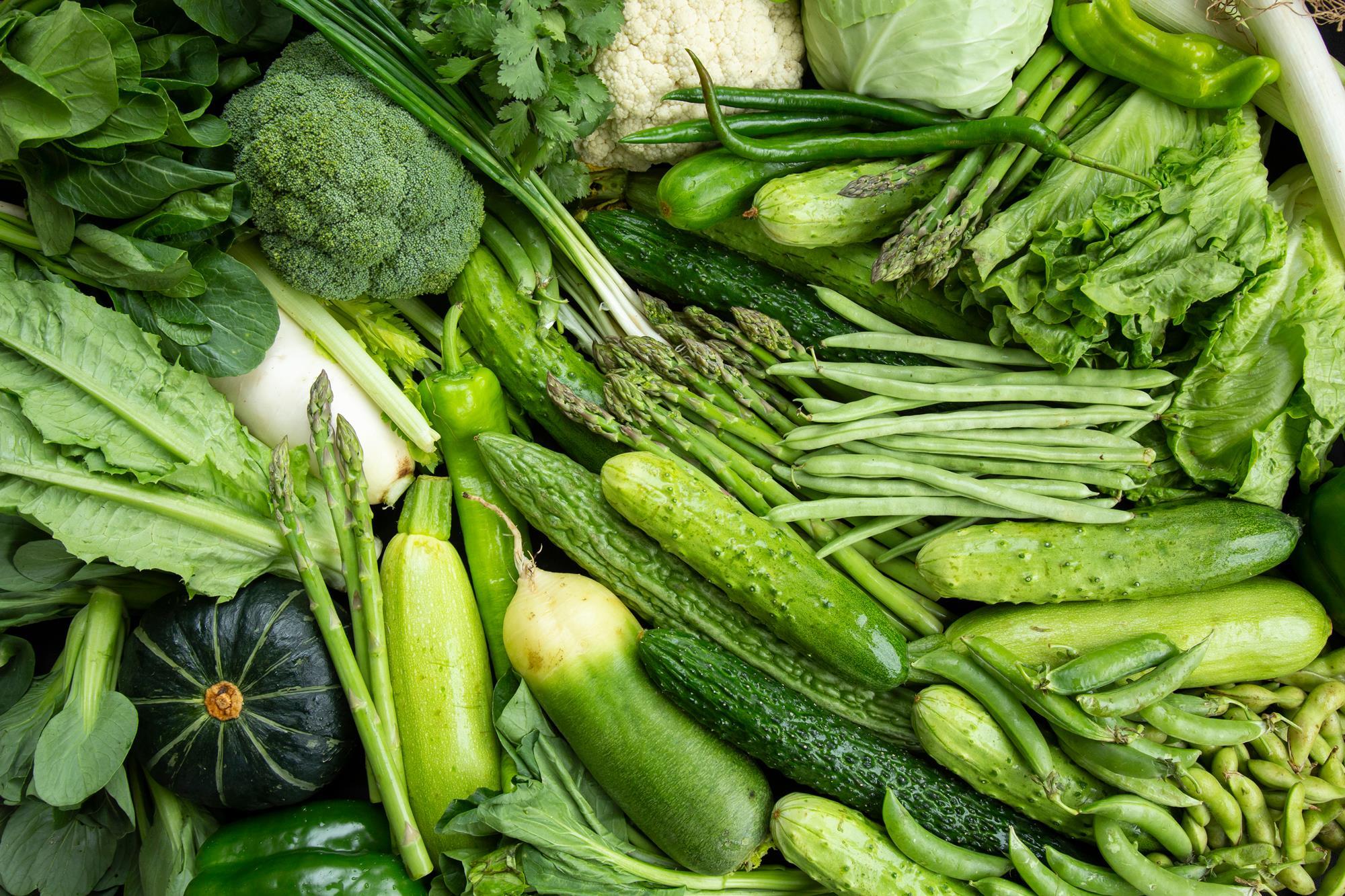 An assortment of vegetables fill the image; this includes broccoli, cauliflower, cucumber, runner beans, asparagus, and…