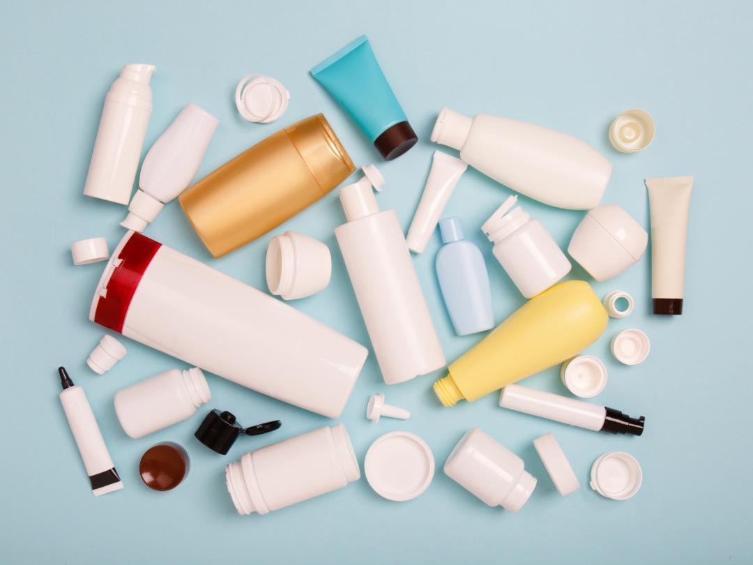 A range of different kinds of plastic HDPE bottles set against a light blue background