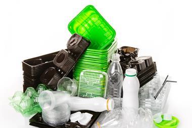 A pile of polyethylene plastic packaging, including food trays, bottles, cups, lids, sauce pots and straws.