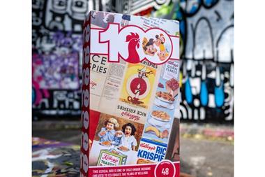 A photograph of a Kellogg's cereal box. It has been printed with a collage of vintage advertisements. The on-pack text reads, 'this cereal box is one of 2022 unique designs created to celebrate 100 years of Kellogg 'bringing breakfast to Britain'.'