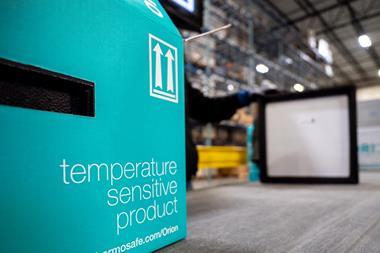 A blue cardboard box sits in the foreground. It reads, 'temperature sensitive product, thermosafe.com/Orion'. A worker and the interior of a warehouse can be seen in the background.