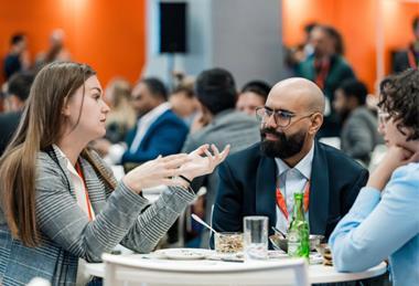 Three Sustainable Packaging Summit delegates sat talking around a table