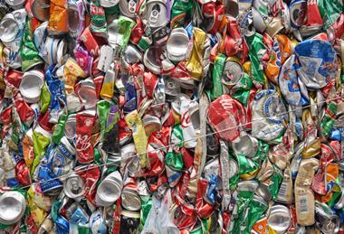 Lots of crushed cans gathered into a bale