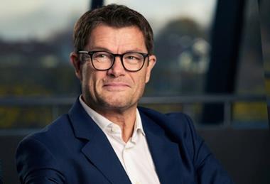 A picture of the author of the article: a man with glasses smiling