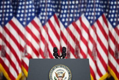 Empty Tribune for Speeches American President Against the American Flags Background.
