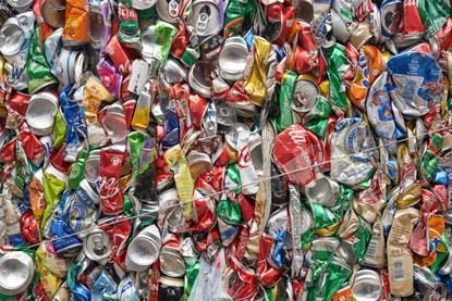 Lots of crushed cans gathered into a bale