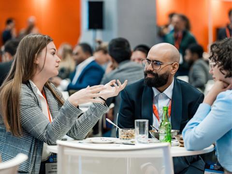 Three Sustainable Packaging Summit delegates sat talking around a table