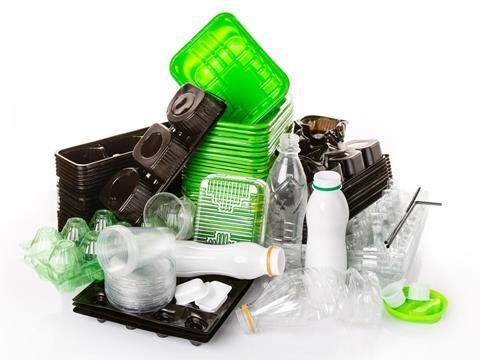 A pile of polyethylene plastic packaging, including food trays, bottles, cups, lids, sauce pots and straws.