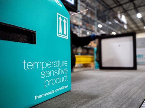 A blue cardboard box sits in the foreground. It reads, 'temperature sensitive product, thermosafe.com/Orion'. A worker and the interior of a warehouse can be seen in the background.