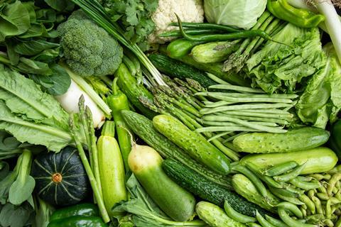 An assortment of vegetables fill the image; this includes broccoli, cauliflower, cucumber, runner beans, asparagus, and lettuce.