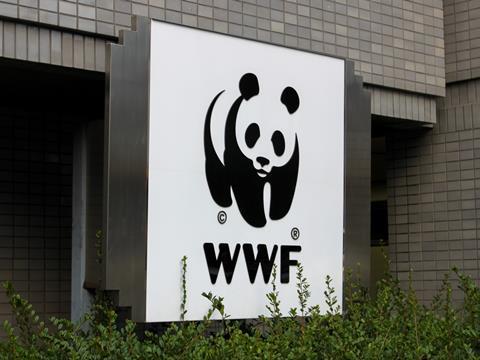 A WWF sign is visible above the foliage outside a building.