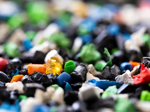 A close-up on colourful flakes of shredded plastic.