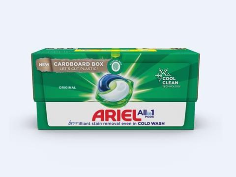 Against a white background, a green cardboard box for Ariel All in 1 Pods, which is written in red and blue text at the centre bottom of the box above text reading ‘brrilliant stain removal even in COLD WASH’. The box features a graphic of a blue, green, and white laundry capsule in the centre, while a circle above it shows a fingerprint with the text ‘Ecoclic box’. A graphic on the left of the box gives the impression of the box’s coating being peeled to reveal a line of cardboard with the text ‘New cardboard box’ and ‘Let’s cut plastic!’ overlaid. In the top right corner, there is a graphic of a snowflake with a third cut away to make space for text reading ‘Cool clean technology’.