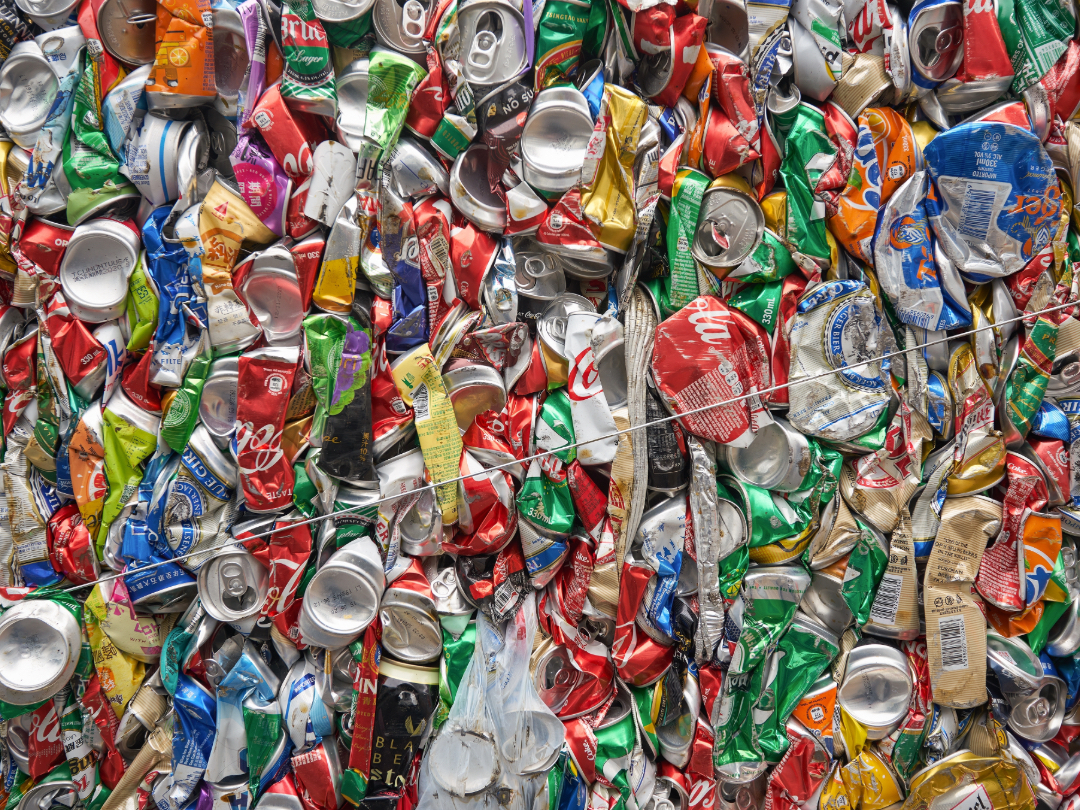 Lots of crushed cans gathered into a bale